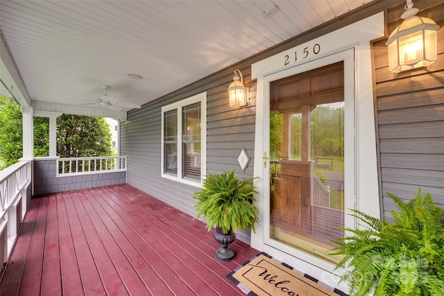 wooden terrace featuring ceiling fan and covered porch