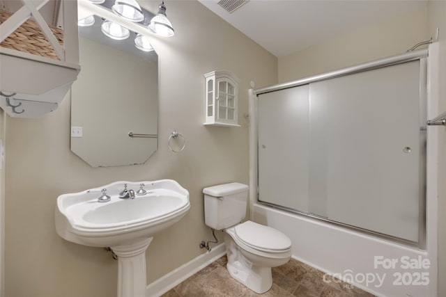 bathroom featuring shower / bath combination with glass door, toilet, visible vents, and baseboards