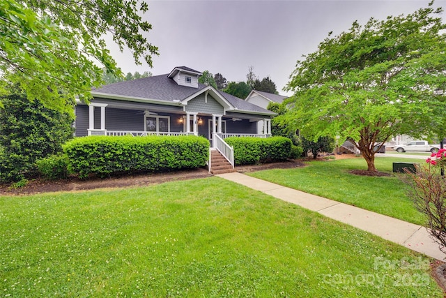 bungalow-style home featuring roof with shingles, a porch, and a front yard