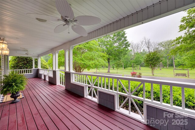 wooden terrace featuring covered porch and a ceiling fan