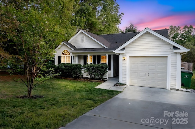 ranch-style house with an attached garage, driveway, and a front lawn