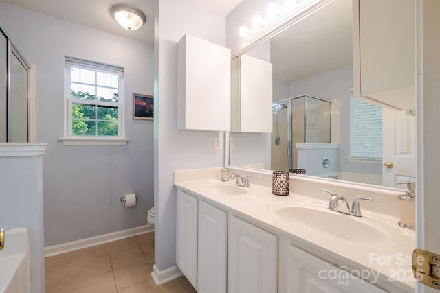 full bathroom featuring tile patterned floors, toilet, a sink, and a stall shower