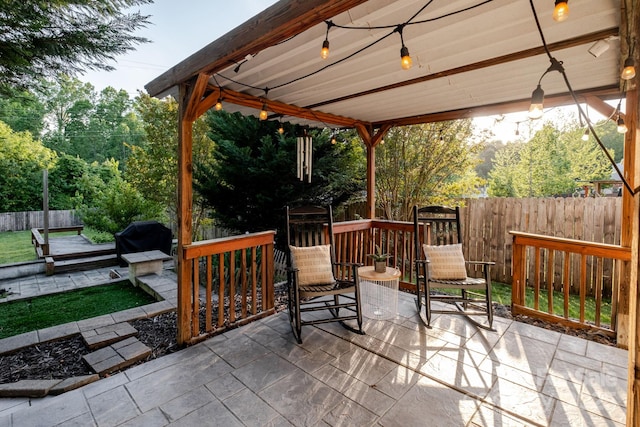 view of patio / terrace with grilling area and fence