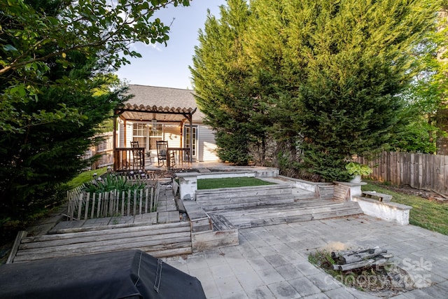 exterior space with a pergola, fence, and a deck