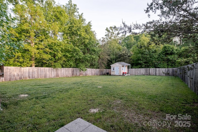 view of yard featuring a fenced backyard, an outbuilding, and a shed