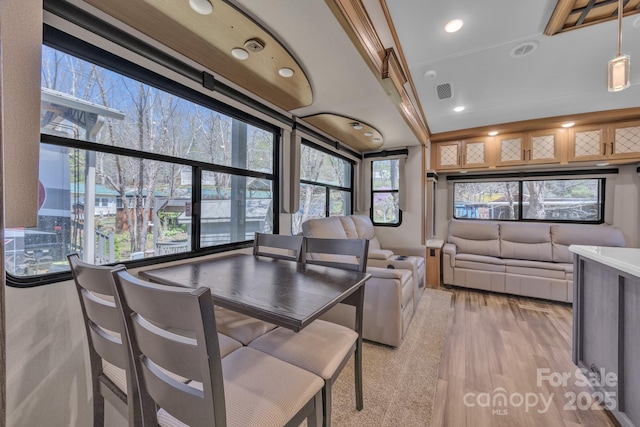 dining room with plenty of natural light, recessed lighting, and light wood-style flooring