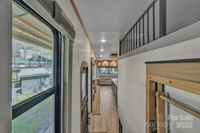 corridor featuring wood finished floors and recessed lighting