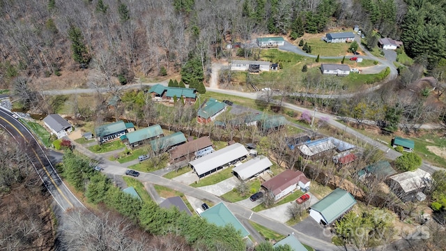 view of property location with a heavily wooded area