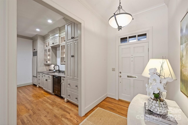 entrance foyer with baseboards, light wood-style floors, and crown molding