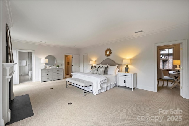 carpeted bedroom featuring a fireplace with flush hearth, visible vents, ornamental molding, baseboards, and ensuite bathroom