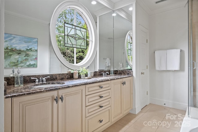 bathroom with ornamental molding, tile patterned flooring, and a sink