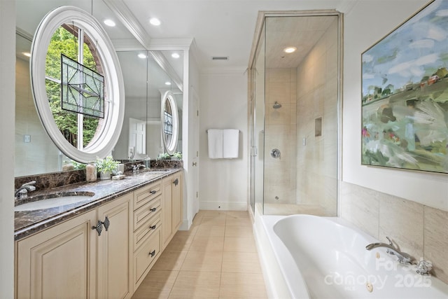 bathroom featuring tile patterned flooring, visible vents, a sink, a garden tub, and a stall shower
