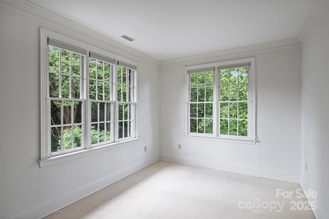 unfurnished room featuring baseboards, visible vents, and a wealth of natural light