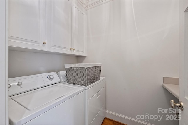 laundry area with wood finished floors, baseboards, independent washer and dryer, and cabinet space