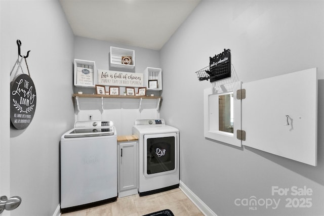 washroom with independent washer and dryer and baseboards