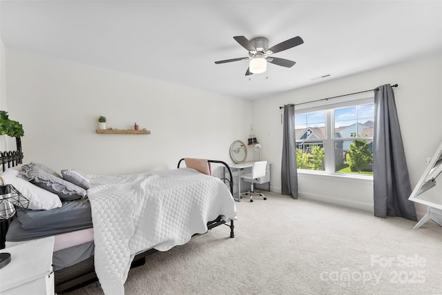 carpeted bedroom featuring baseboards and ceiling fan