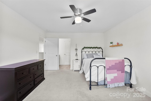 carpeted bedroom with baseboards and a ceiling fan