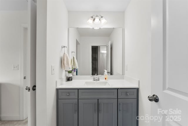 bathroom with vanity and baseboards