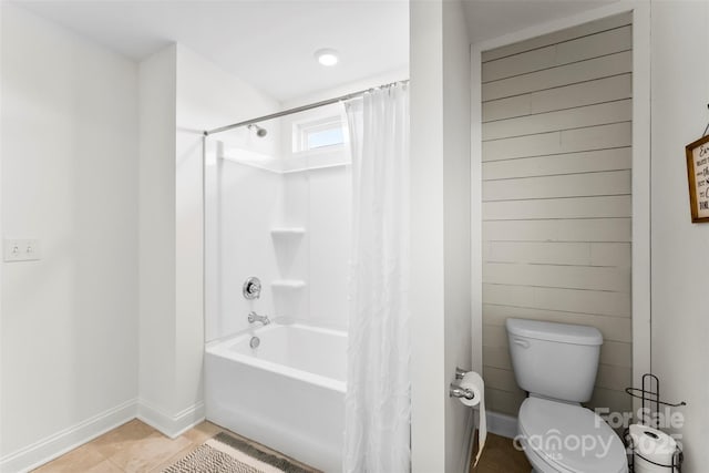 full bathroom featuring toilet, baseboards, shower / bath combination with curtain, and tile patterned floors