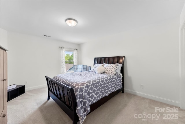 bedroom featuring light colored carpet and baseboards