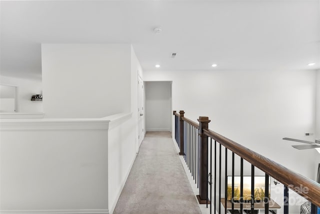 hall with light carpet, recessed lighting, baseboards, and an upstairs landing