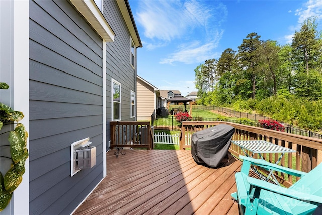 wooden terrace with a fenced backyard