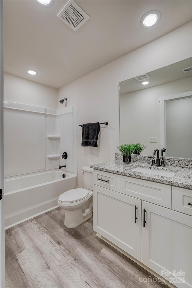721 32nd St NE, Conover, NC 28613 - bathroom featuring wood finished floors, vanity, shower / washtub combination, toilet, and visible vents