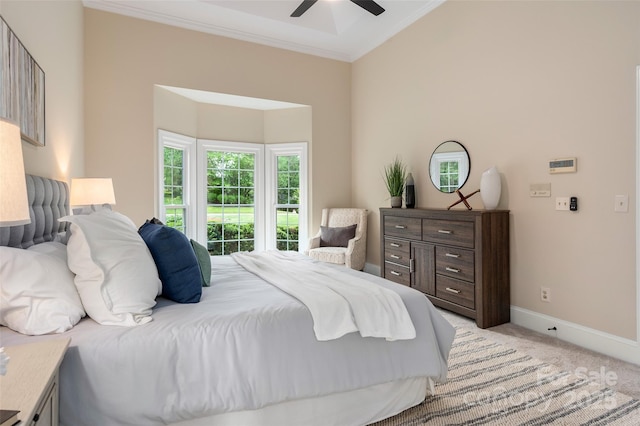 bedroom with baseboards, ornamental molding, a ceiling fan, and light carpet