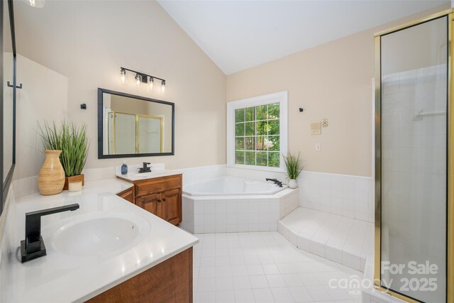 full bathroom with a shower stall, vanity, a garden tub, tile patterned flooring, and lofted ceiling