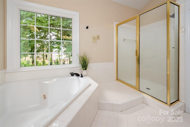 full bath with a healthy amount of sunlight, a whirlpool tub, and a stall shower
