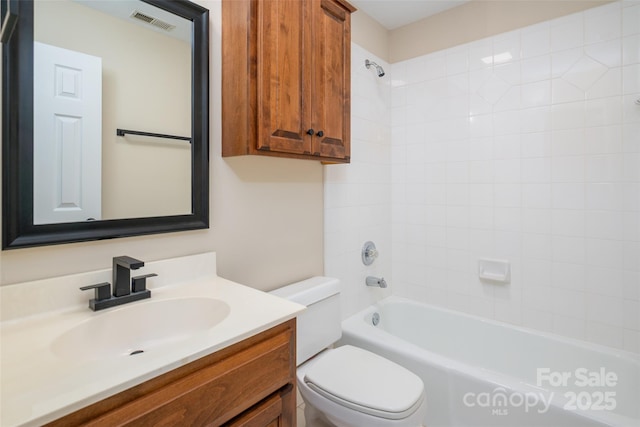 bathroom with visible vents, toilet, bathtub / shower combination, and vanity
