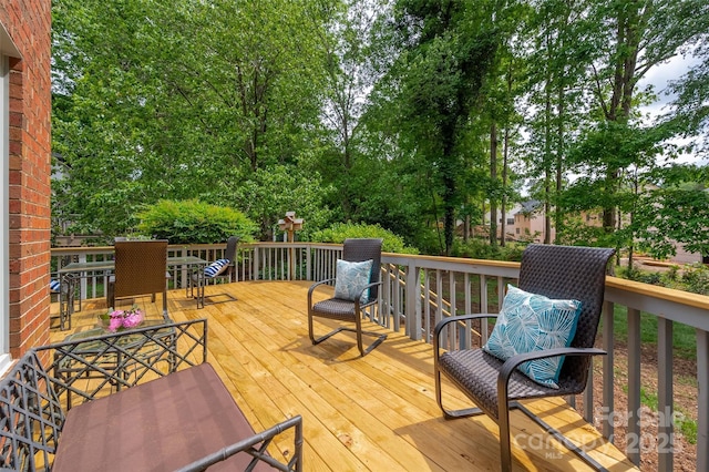 wooden terrace featuring outdoor dining area