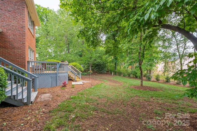 view of yard featuring a deck and stairs