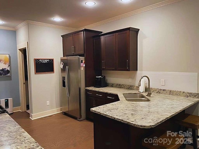 29 Woodbridge Park Dr, Asheville, NC 28803 - kitchen featuring stainless steel fridge with ice dispenser, a sink, dark brown cabinets, ornamental molding, and dark wood-style floors