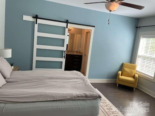 29 Woodbridge Park Dr, Asheville, NC 28803 - bedroom featuring baseboards, wood finished floors, a barn door, and ceiling fan