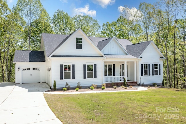 modern farmhouse featuring a garage, roof with shingles, board and batten siding, a porch, and driveway