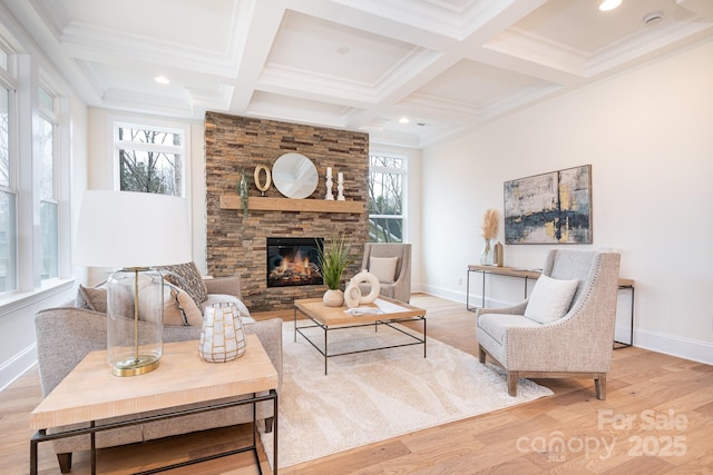 living area with beam ceiling, a fireplace, baseboards, wood finished floors, and coffered ceiling