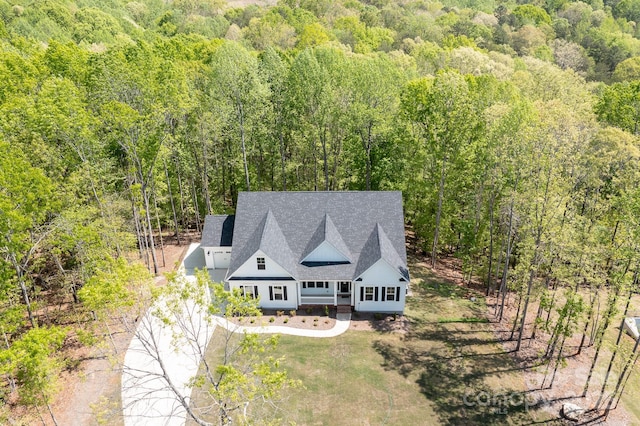 drone / aerial view with a wooded view