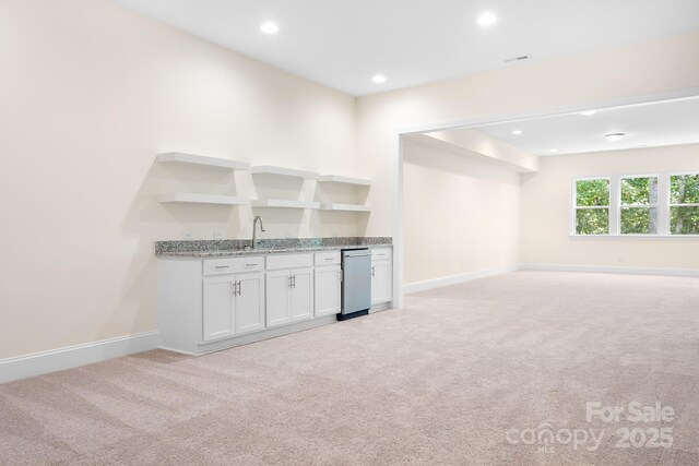 bar with baseboards, recessed lighting, wet bar, and light colored carpet