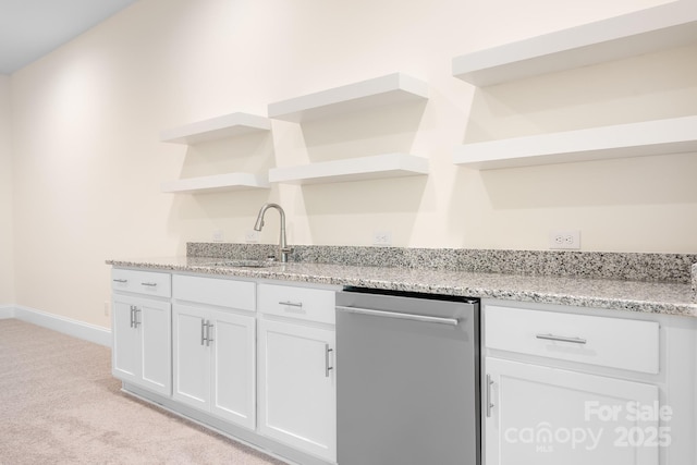 bar with stainless steel dishwasher, baseboards, light colored carpet, a sink, and wet bar