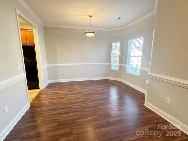 unfurnished dining area with dark wood finished floors, baseboards, and crown molding