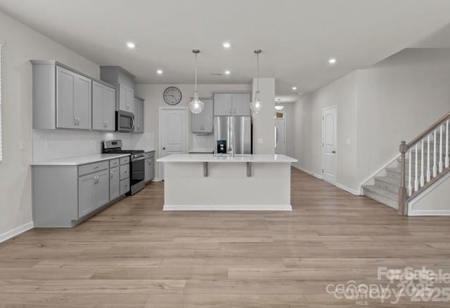 5024 Colline Ct, Charlotte, NC 28216 - kitchen with appliances with stainless steel finishes, gray cabinetry, baseboards, light wood-style flooring, and light countertops