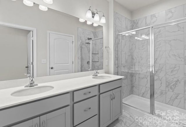 5024 Colline Ct, Charlotte, NC 28216 - bathroom featuring marble finish floors, a stall shower, and double vanity
