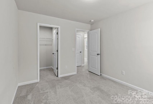 5024 Colline Ct, Charlotte, NC 28216 - unfurnished bedroom with carpet flooring, a walk in closet, baseboards, and a closet