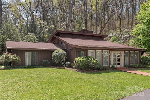 22 Waynewood Dr, Waynesville, NC 28786 - prairie-style house with a front yard, roof with shingles, french doors, and a chimney