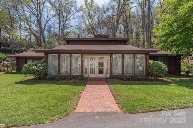 22 Waynewood Dr, Waynesville, NC 28786 - exterior space featuring board and batten siding, a front yard, french doors, and a sunroom