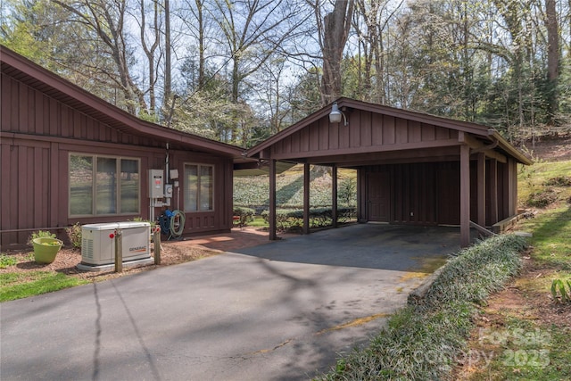 22 Waynewood Dr, Waynesville, NC 28786 - view of side of home with board and batten siding, a carport, and driveway