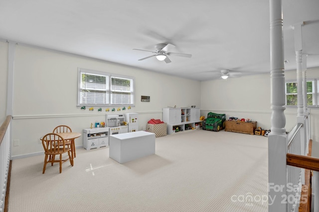 recreation room featuring carpet floors, baseboards, and ceiling fan
