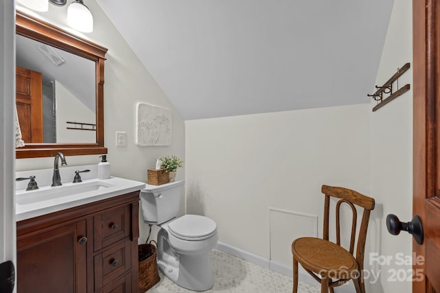 half bathroom with vaulted ceiling, visible vents, toilet, and vanity