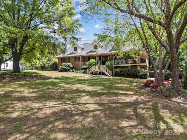 view of yard featuring covered porch and stairs